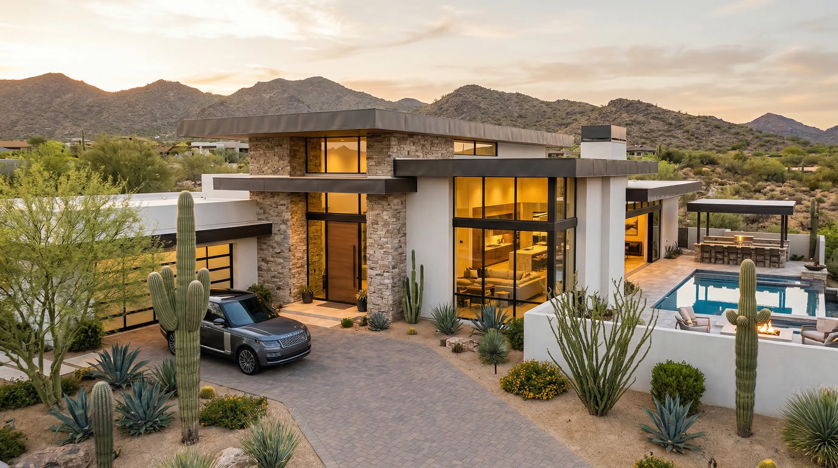 Desert contemporary home in Scottsdale with pool, mountain views, and a Range Rover in the driveway